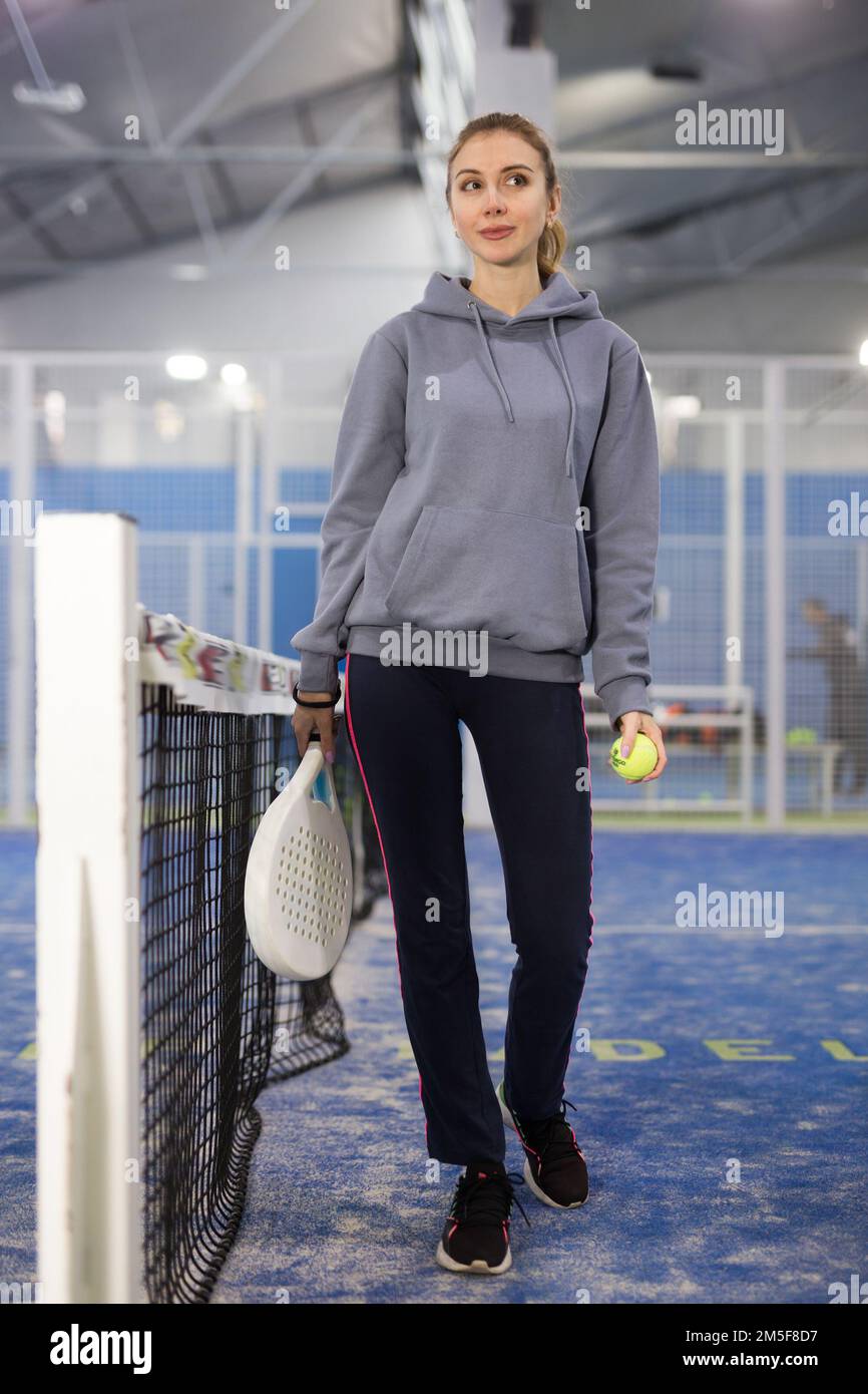 Porträt einer jungen Tennisspielerin, die mit einem Padel-Schläger steht Stockfoto