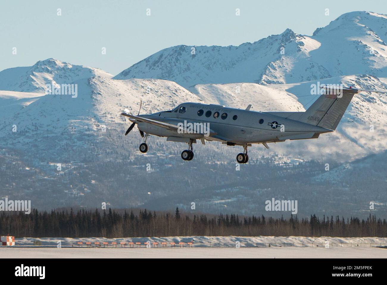 Ein C-12F Huron, der der 517. Airlift-Geschwader zugeteilt wurde, startet am 14. März 2022 auf der Joint Base Elmendorf-Richardson, Alaska. Der C-12F Huron verfügt über ein einziehbares dreirädriges Fahrwerk, ein lenkbares Nasenrad und vier Propeller. Stockfoto