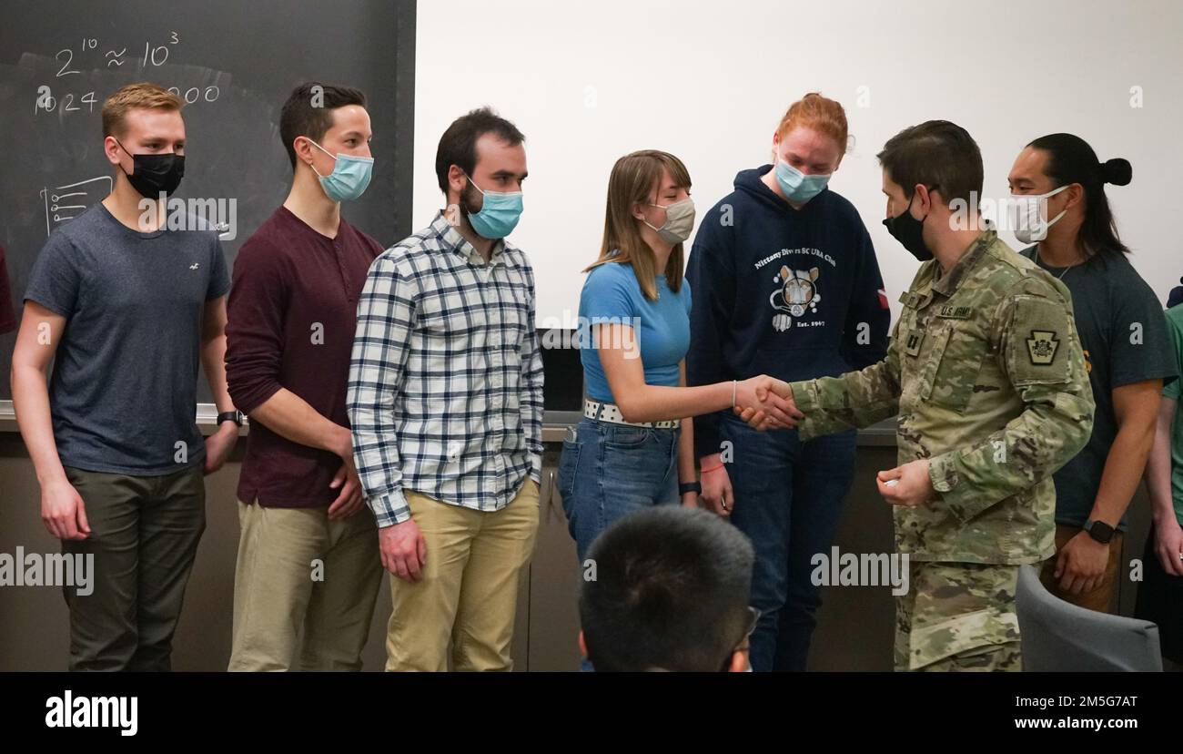 Captain Sean Smith, rechts, stellvertretender Cyber-Chief des Pennsylvania National Guard Defensive Cyber Operations Elementteams, Und ein aus dem Libanon stammender Vater verleiht einem Studenten der Penn State University einen Preis dafür, dass er während der PA National Guard Wi-Fighter Cyber Challenge an der Penn State University am 16. März 2022 unter den Top 10 abgeschnitten hat. Mehr als 40 Studenten haben sich für eine Reihe von Hacking- und Cybersicherheitsherausforderungen angemeldet Stockfoto