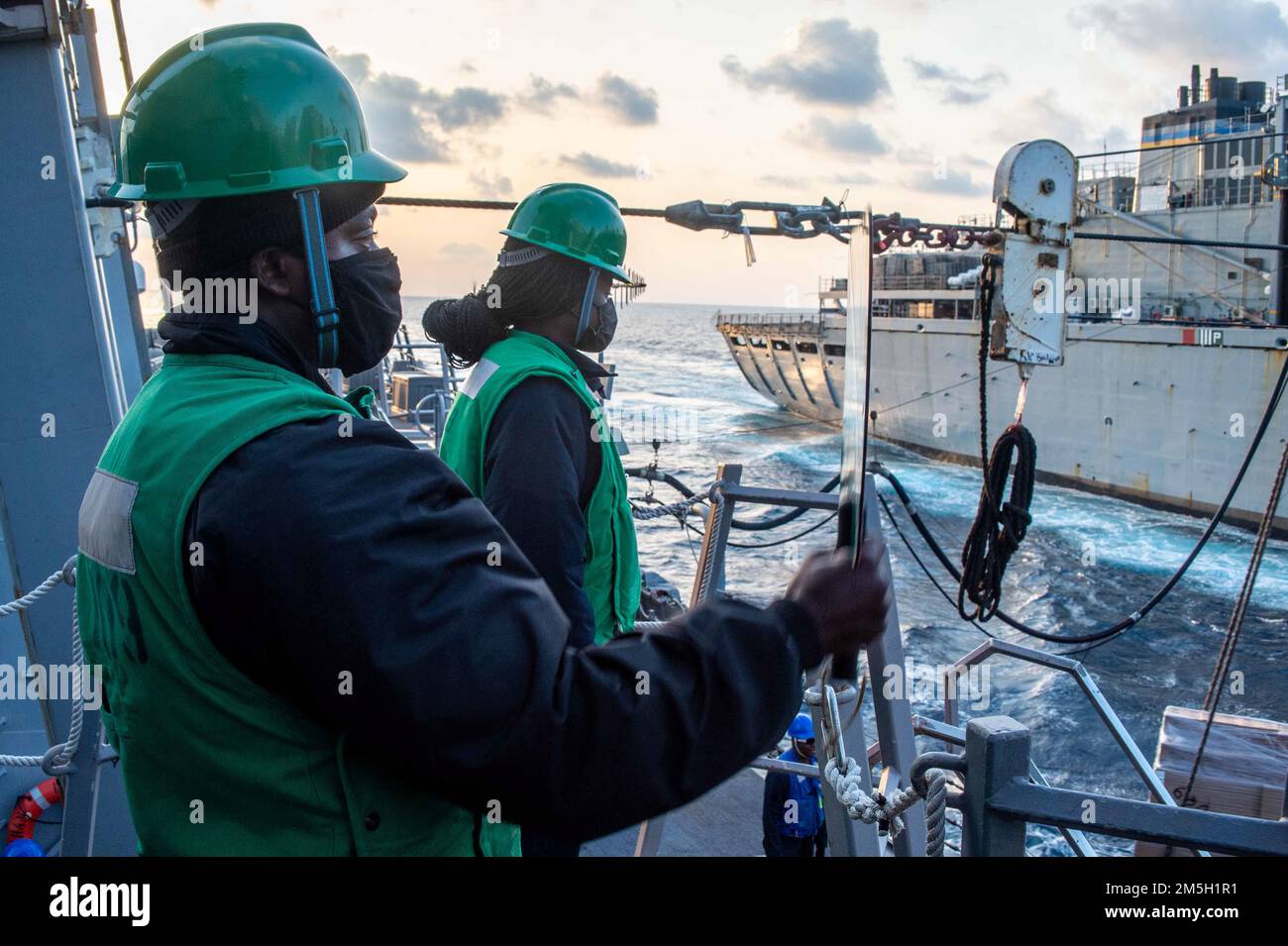 220317-N-UP745-1036 SEA OF CRETE (17. März 2022) Professional Apprenticeship Career Trakt Seaman (PACT) Jeremie Tsonya, aus New York City, Front, Und PACT Seaman Zahahria Howard, aus Austin, Texas, signalisiert während einer Wiederauffüllung auf See an Bord des Arleigh-Burke-Class-Guided-Missile Destroyer USS Jason Dunham (DDG 109) am 17. März 2022 eine eingehende Palette vom Supply-Class-Fast-Combat-Hilfsschiff USNS Supply (T-AOE-6). Jason Dunham ist Teil der Harry S. Truman Carrier Strike Group und befindet sich auf einem geplanten Einsatz im US-Flottenbereich 6. zur Unterstützung von US-amerikanischen, alliierten und Partner Intere Stockfoto