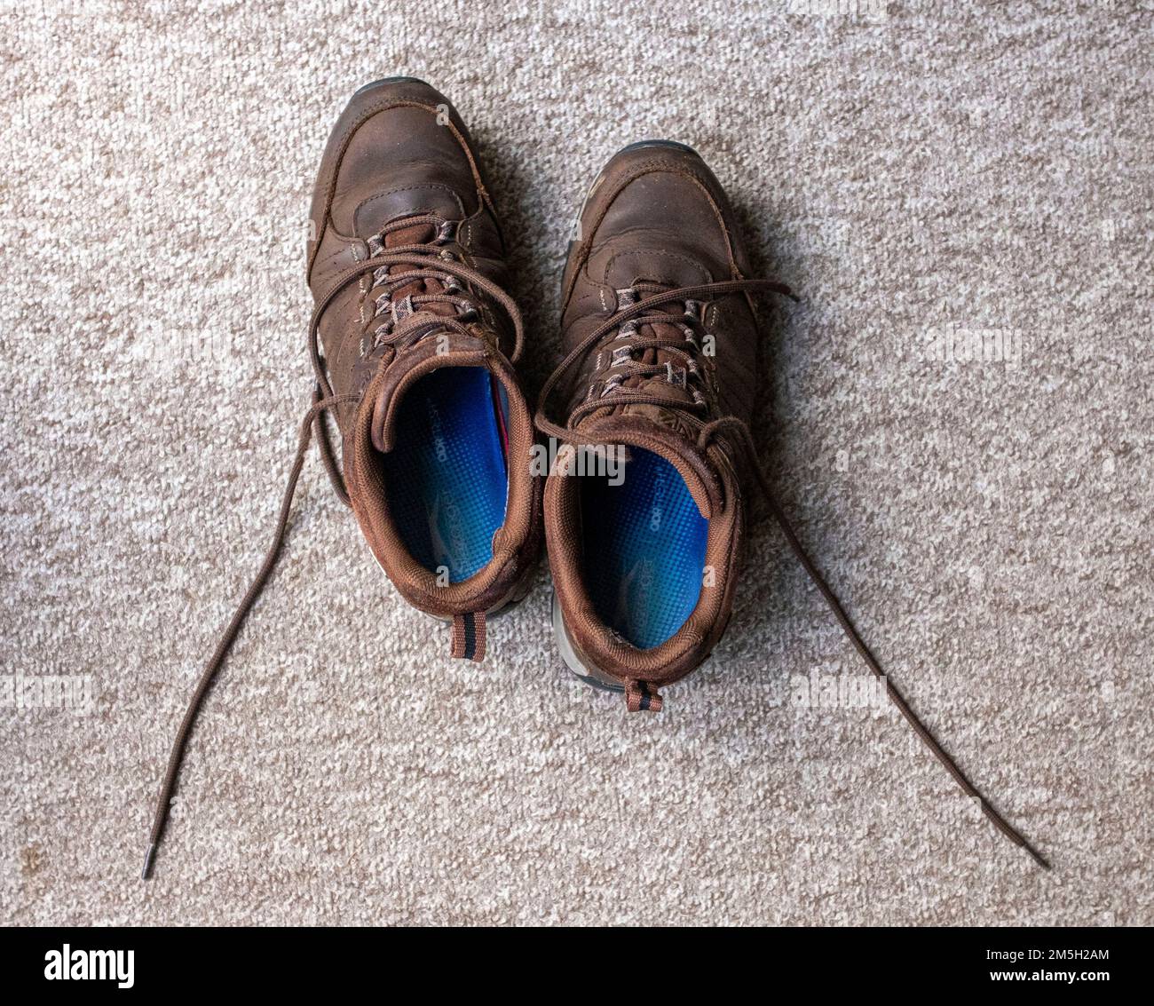 Robuste Laufschuhe mit offenen Schnürsenkeln im Teich UK Stockfoto