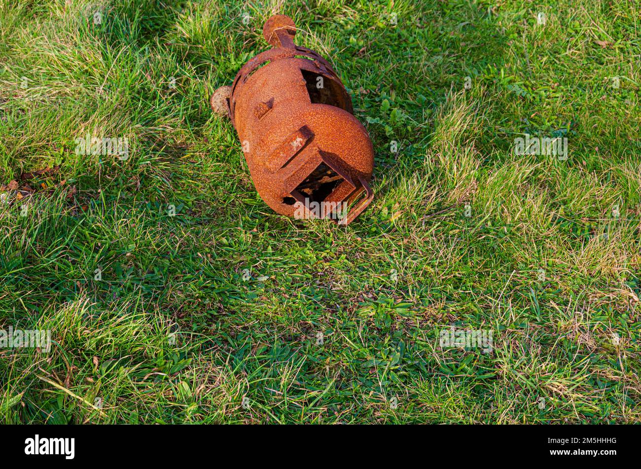 Alter verrosteter Holzbrenner, der am Rande des Grases im Tyrella Beach County in Nordirland entsorgt wurde Stockfoto