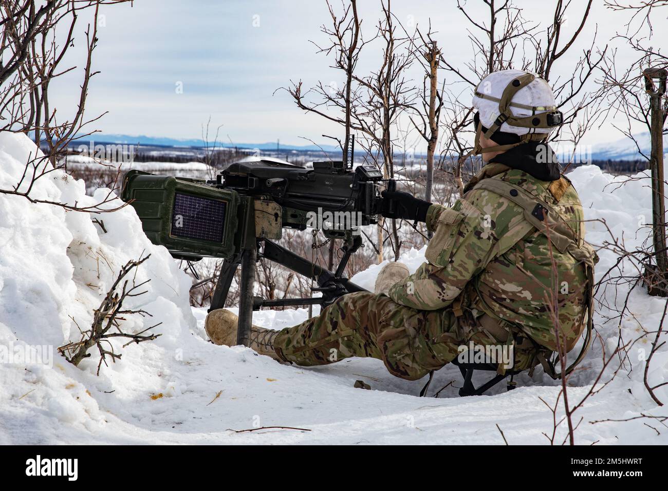 Staff Sgt. Jeff Early, A Paratrooper from Apache Company, 1. Bataillon, 501. Parachute Infanterie Regiment, 4. Infanterie Brigade Combat Team (Airborne), 25. Infanterie Division, ‚Spartan Brigade,‘ mans der MK 19 Granatenwerfer an einem Beobachtungspunkt während des Joint Pacific Multinational Readiness Center 22-02, 18. März 2022. JPMRC 22-02, ausgeführt in Alaska mit seinen erstklassigen Trainingseinrichtungen und der rauen arktischen Umgebung, baut Soldaten und Anführer zu einem Team aus erfahrenen, harten, aufmerksamen und anpassungsfähigen Kriegern zusammen, die überall kämpfen und gewinnen können. Stockfoto