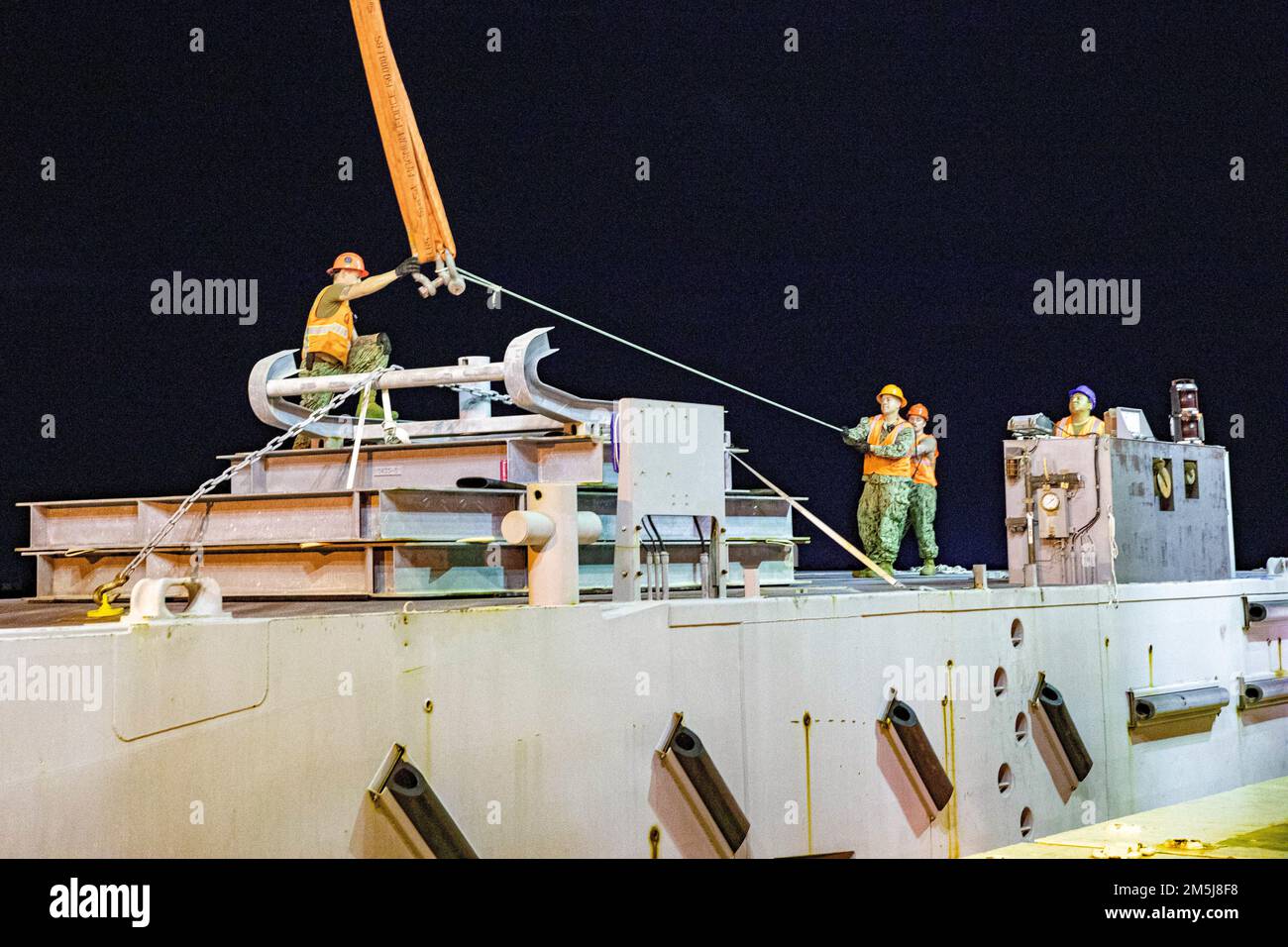 USA Navy Sailors mit Navy Cargo Handling Battalion 1, heben ein Strandmodul, Teil des verbesserten Navy Lighterage System, an Bord der USNS 1. LT. Jack Lummus (T-AK 3011) zur Unterstützung der 3. Marine Logistics Group während der Übung Atlantic Dragon auf Marine Corps Support Facility Blount Island, Florida, USA, 18. März 2022. Atlantic Dragon ist eine Übung zur Kraftgenerierung, bei der das Kampflogistikrevier 37 als Ankunftsgruppe eingesetzt wird, um taktische logistische Unterstützung für die III Marine Expeditionary Force zu leisten. Die Übung besteht aus einer experimentellen Seekraft von Stockfoto