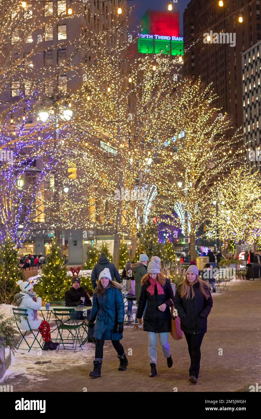 Detroit, Michigan - Women Walk im Campus Martius Park in der Innenstadt von Detroit, dekoriert für die Winterferien. Stockfoto