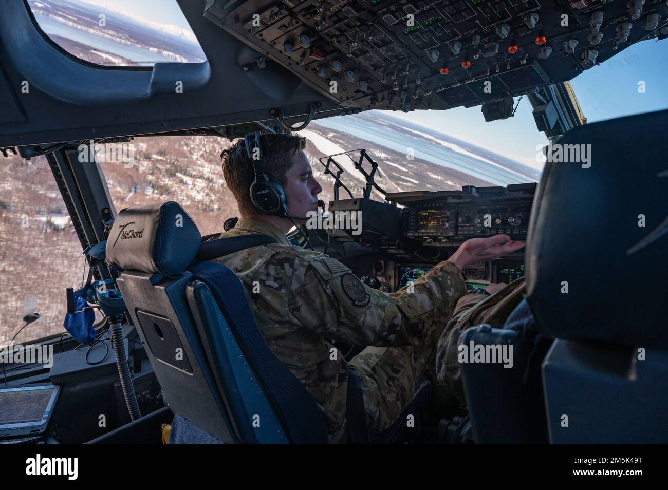 USA Air Force Captain Taylor Williams, Left und U.S. Air Force Captain Michael Cooper, beide Piloten des 8. Airlift-Geschwaders, fliegen über die Alaska Range, Alaska, 21. März 2022, während der Übung Rainer war 22A. Die Übung soll die Fähigkeit des 62. Airlift-Flügels demonstrieren, zu operieren und zu überleben, während gleichzeitig Herausforderungen für den militärischen Vorteil der USA in allen Betriebsbereichen – Luft, Land, See und Cyberspace – überwunden werden. Stockfoto