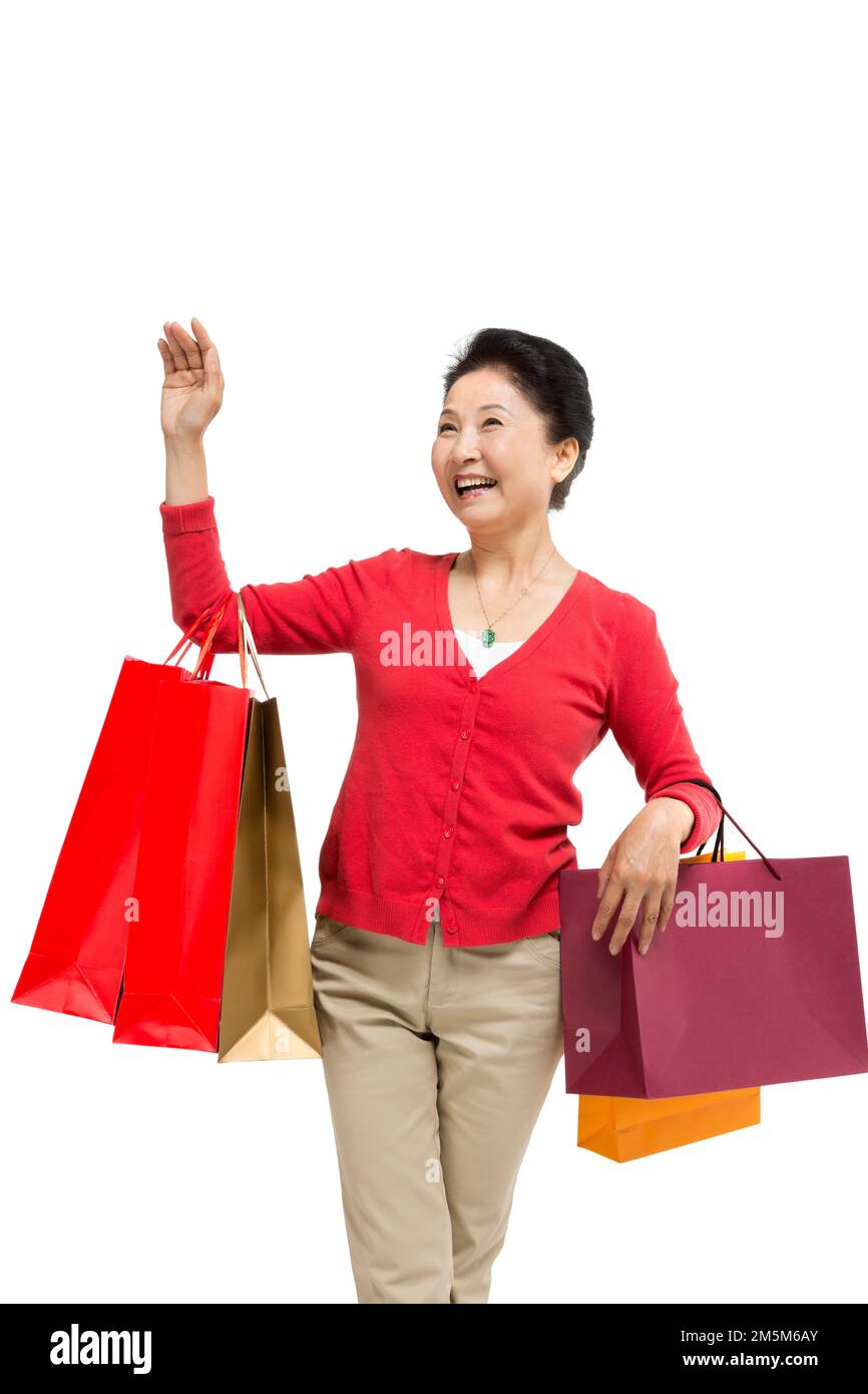 Zelt bis zu Frauen mittleren Alters und alten Frauen, die Einkaufstaschen tragen Stockfoto