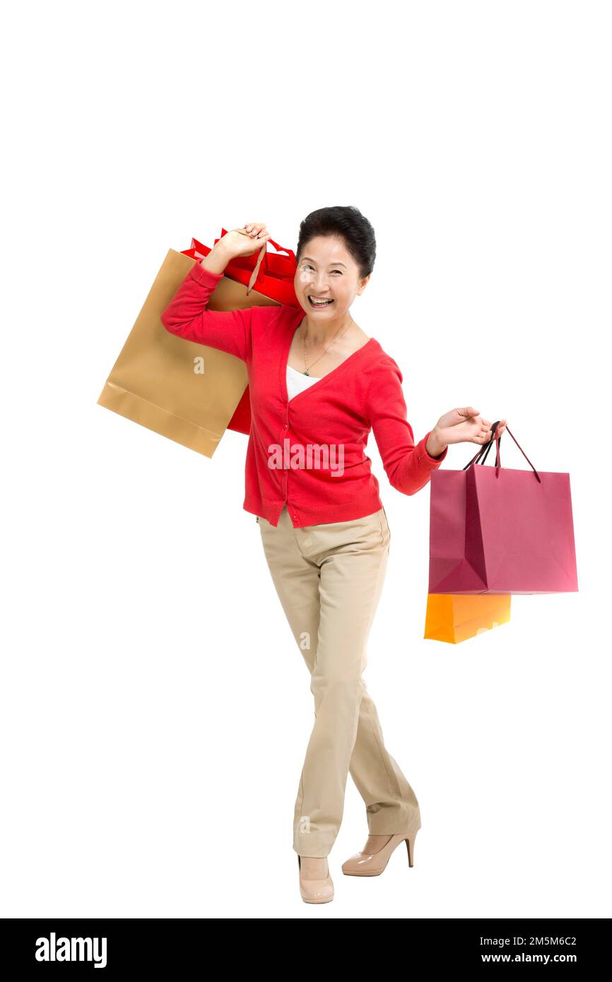 Zelt bis zu Frauen mittleren Alters und alten Frauen, die Einkaufstaschen tragen Stockfoto