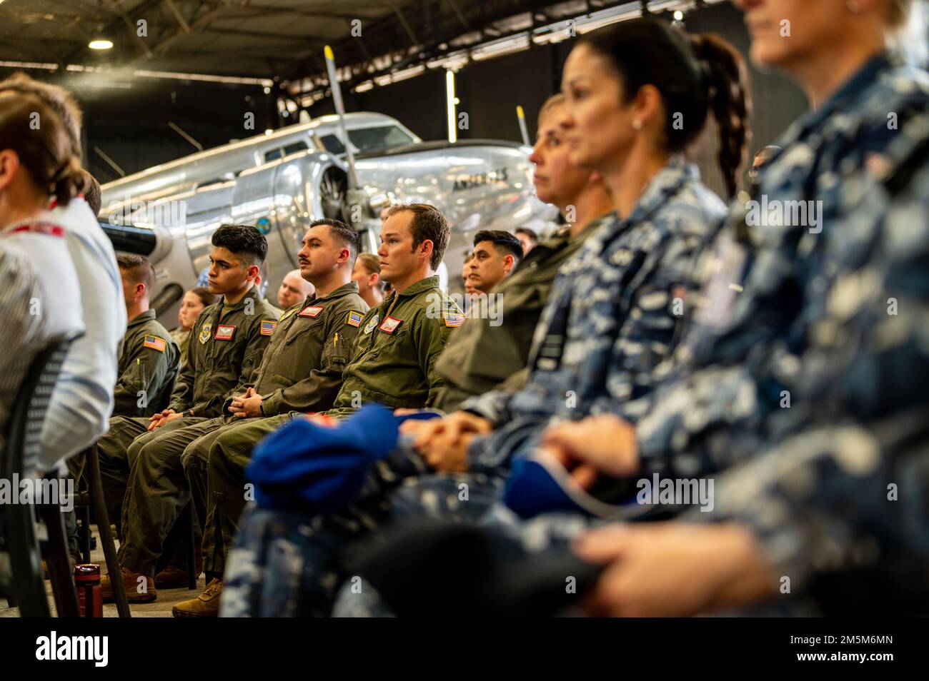 USA Air Force Airmen sitzen zusammen mit Mitgliedern der Australian Defence Force bei einer Zeremonie zum Kulturerbe auf der RAAF Base Amberley, Queensland, 24. März 2022. Die derzeit auf dem Luftwaffenstützpunkt Travis in Kalifornien stationierte 22. Luftwaffenstaffel feierte den 80. Jahrestag ihrer Gründung mit einem Besuch auf der RAAF-Basis Amberley vom 23. Bis 27. März 2022. Das Geschwader wurde am 3. April 1942 als 22. Transportgeschwader am Flughafen Essendon in Melbourne, Australien, gegründet, zeitgleich mit der Einrichtung mehrerer RAAF-Transportgeschwader. Der Besuch auf der RAAF-Basis Amberley erlaubte mir USAF-Personal Stockfoto