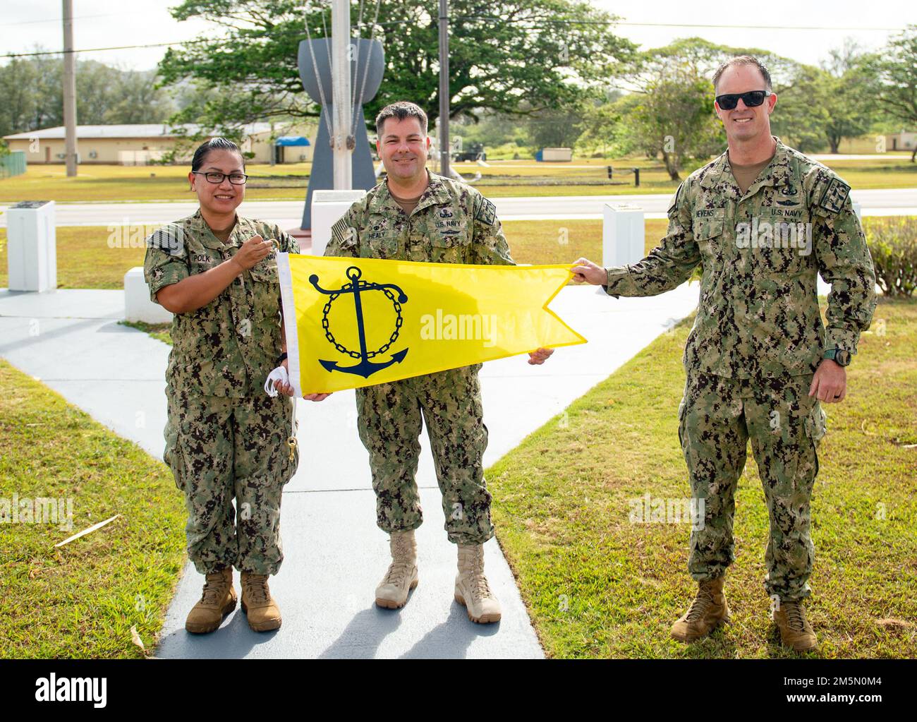 280322-N-WV654-0043 SANTA RITA, Guam (28. März 2022) von links nach rechts, Chief Yeoman Melchar Polk, Captain Gareth Healy, commodore, Commander, Task Force (CTF) 75 und Kommandomeister Matthew Nevens posieren für ein Foto mit dem FY-21 Retention Excellence Award-Fennant. Diese Auszeichnung wurde von der CTF 75 in Anerkennung der Aufrechterhaltung eines überlegenen Militärs verliehen. Stockfoto