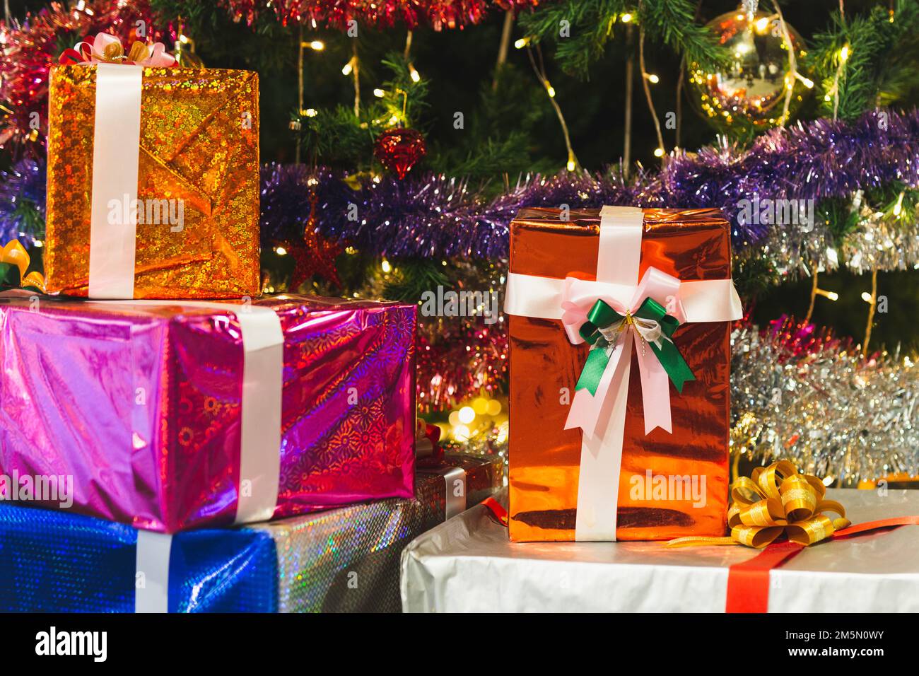 Weihnachtsgeschenke mit Band und Weihnachtsdekorationen feiern das neue Jahr und die Weihnachtszeit. Stockfoto