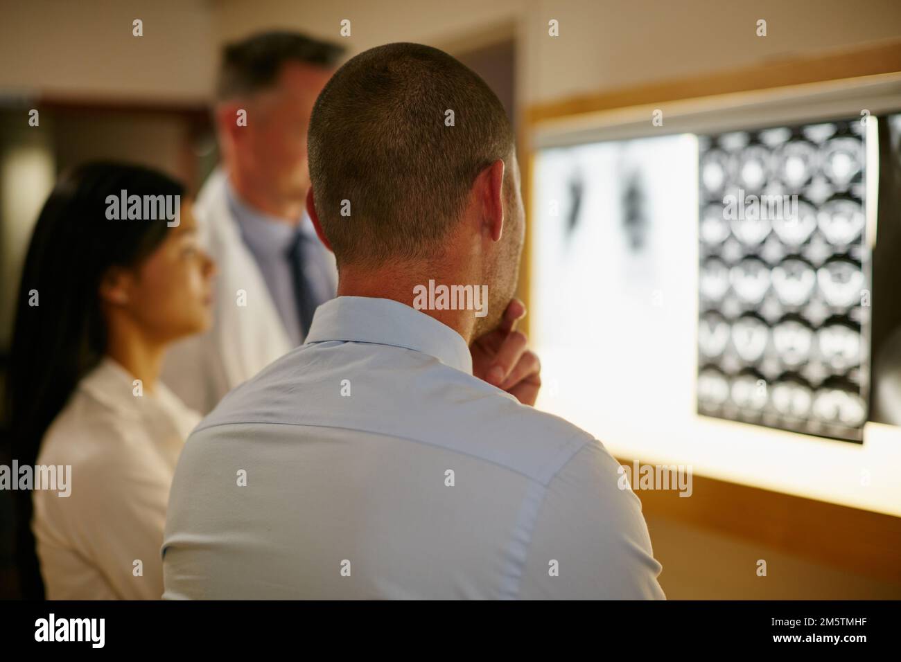 Analyse der internen Teile des Körpers. Ein Team von Chirurgen, die einen Patienten medizinische Scans diskutieren. Stockfoto