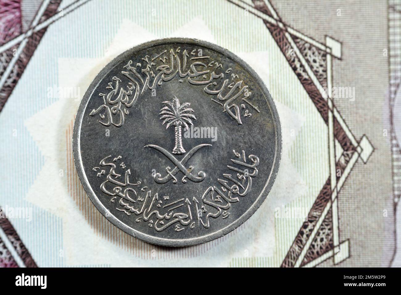 Gekreuzte Schwerter und Palmen in der Mitte der oberen Seite des alten Saudi-Arabien 25 Halalah 25 Halalas Viertel Saudi-Riyal Münze 1400 AH, Translatio Stockfoto