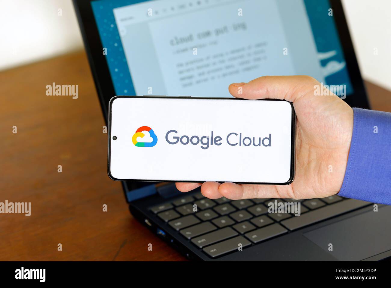 Logo der Google Cloud auf einem Smartphone vor einem Computer. Google Cloud ist ein Cloud-Computing-Technologieunternehmen. Stockfoto