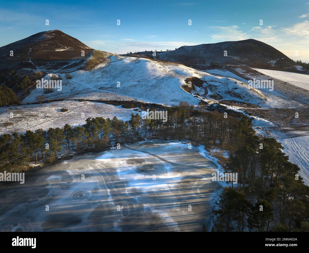Luftaufnahme eines gefrorenen Bowden Loch bei den Eildon Hills an einem frischen sonnigen Tag im Dezember. Der loch ist ein beliebter Ort für Fliegenfischen mit Genehmigung. Stockfoto
