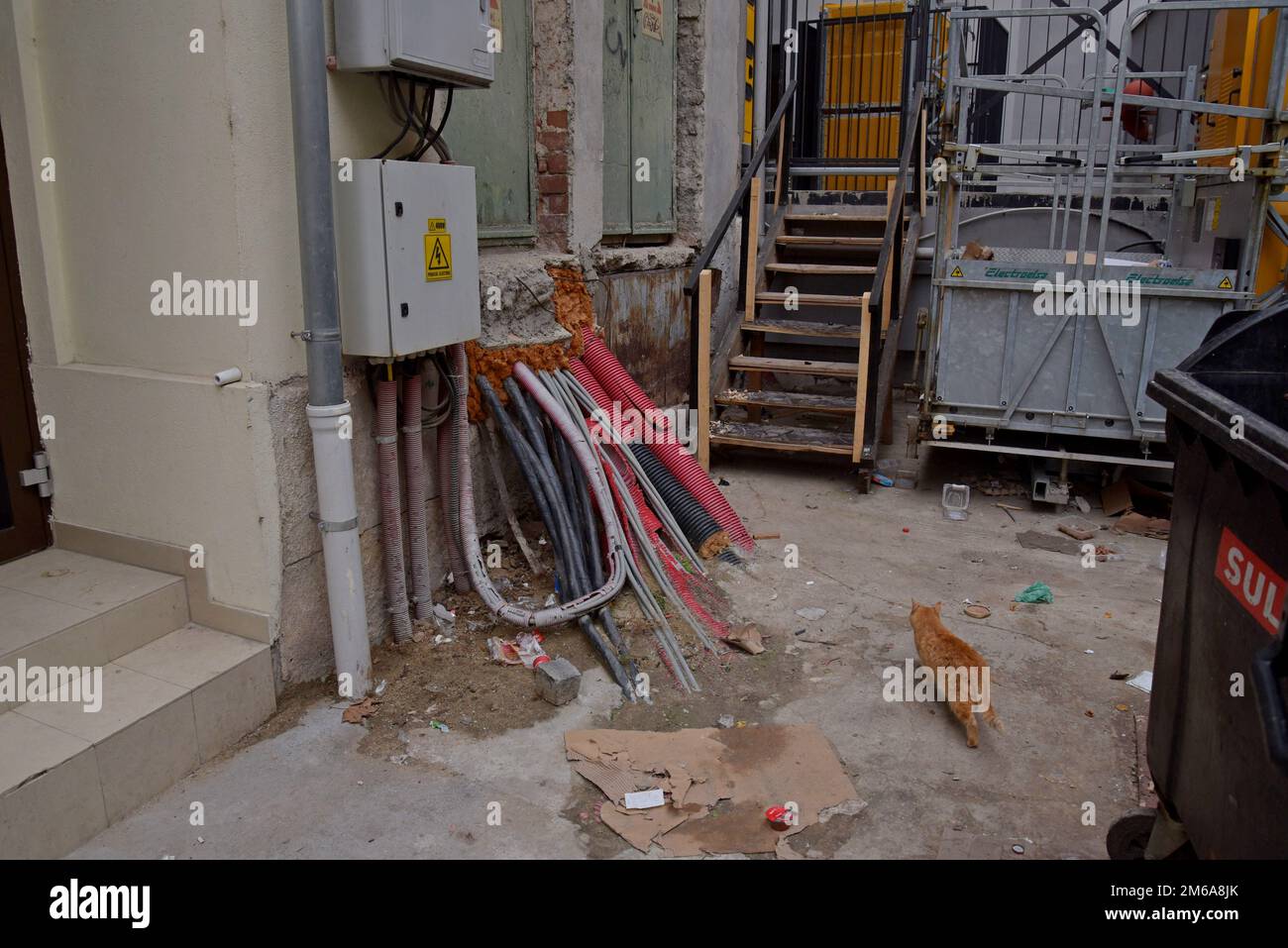 Eine durcheinander geratene Anordnung von Elektrokabeln, die in ein Gebäude in der Straße in Bukarest, Rumänien, münden Stockfoto