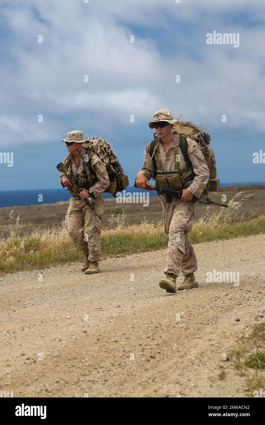 U.S. Marine Corps 1. LT. Michael Carreiro (links), gebürtiger Pittsboro, North Carolina, und Infanterieoffizier, und CPL. Jacob Konefsky, ein gebürtiger Chambersburg, Pennsylvania, und ein Kampfmann, beide mit 1. Bataillons, 2D Marine Regiment, 2D Marine Division (MARDIV), führen eine Wanderung während des Waffen- und Taktikinstruktor-Kurses 2-22 auf der San Clemente Island, Kalifornien, 21. April 2022. WTI ist eine siebenwöchige Trainingsveranstaltung, die von Marine Aviation Weapons and Tactics Squadron One veranstaltet wird, bei der die Entwicklung von kleinen, aufgabenorganisierten Einheiten-Experimenten über alle Kampffunktionen hinweg betont wird, Stockfoto