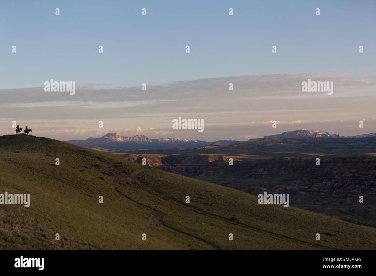 Zwei Cowboys beobachten den Horizont bei Sonnenaufgang. Stockfoto
