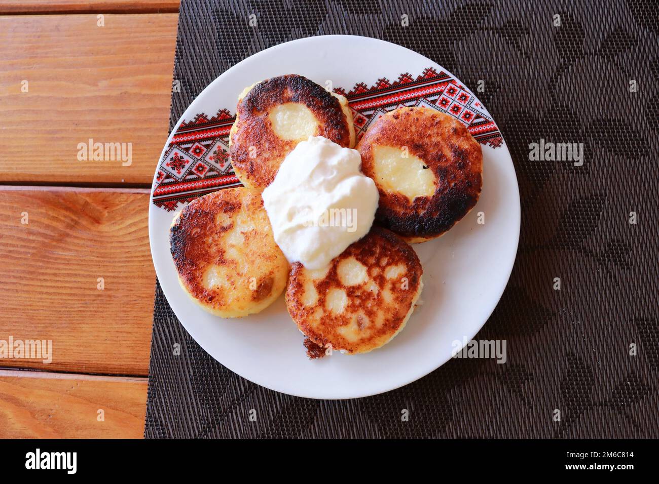 Syrniki - Quark Pfannkuchen, Krapfen von Hüttenkäse - traditionelle ukrainische und russische Küche. Stockfoto