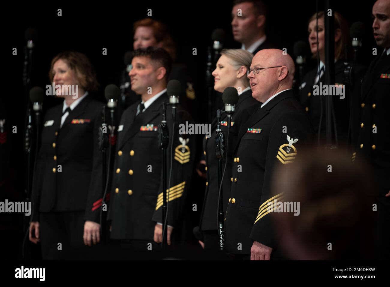 DAYTON, Ohio (25. April 2022) der Chefmusiker David Sigmon, Right, aus Odessa, Texas, singt während eines Konzerts im Dayton Masonic Center mit dem Chor der United States Navy Band Sea Chanters. Die Sea Chanters traten während ihrer 13-Städte-Tour, 2.000 Meilen, in sieben Bundesstaaten auf und verbanden Gemeinden im ganzen Land mit ihrer Navy. Stockfoto