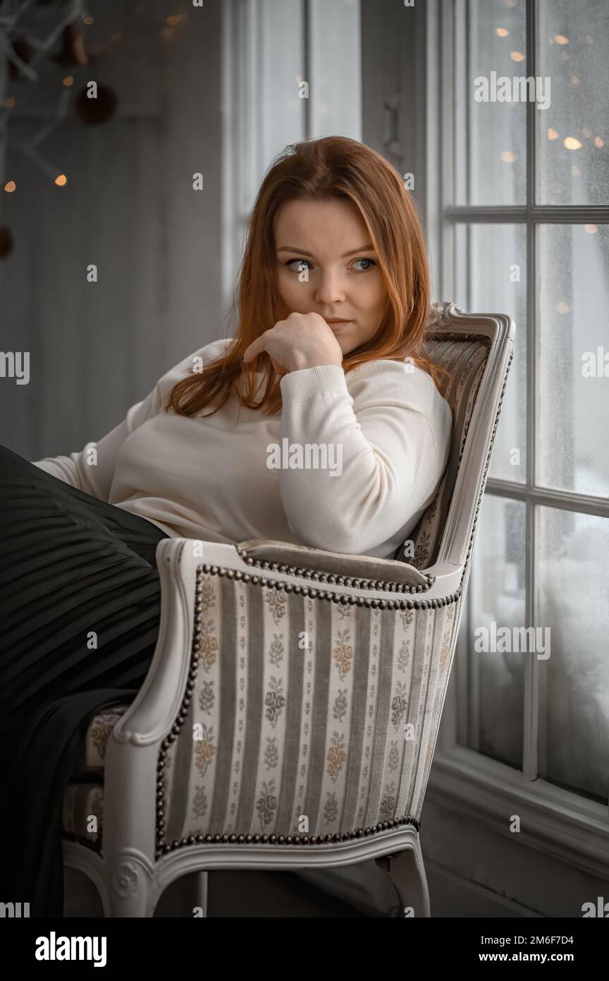 Schönheitsporträt der finnischen skandinavischen Typ kaukasischen Frau sitzt auf Stuhl Stockfoto