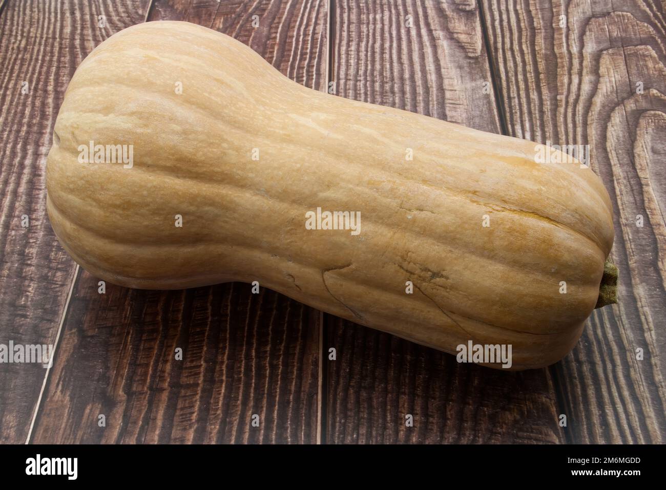 Frischer Butternusskürbis auf Holzhintergrund Stockfoto