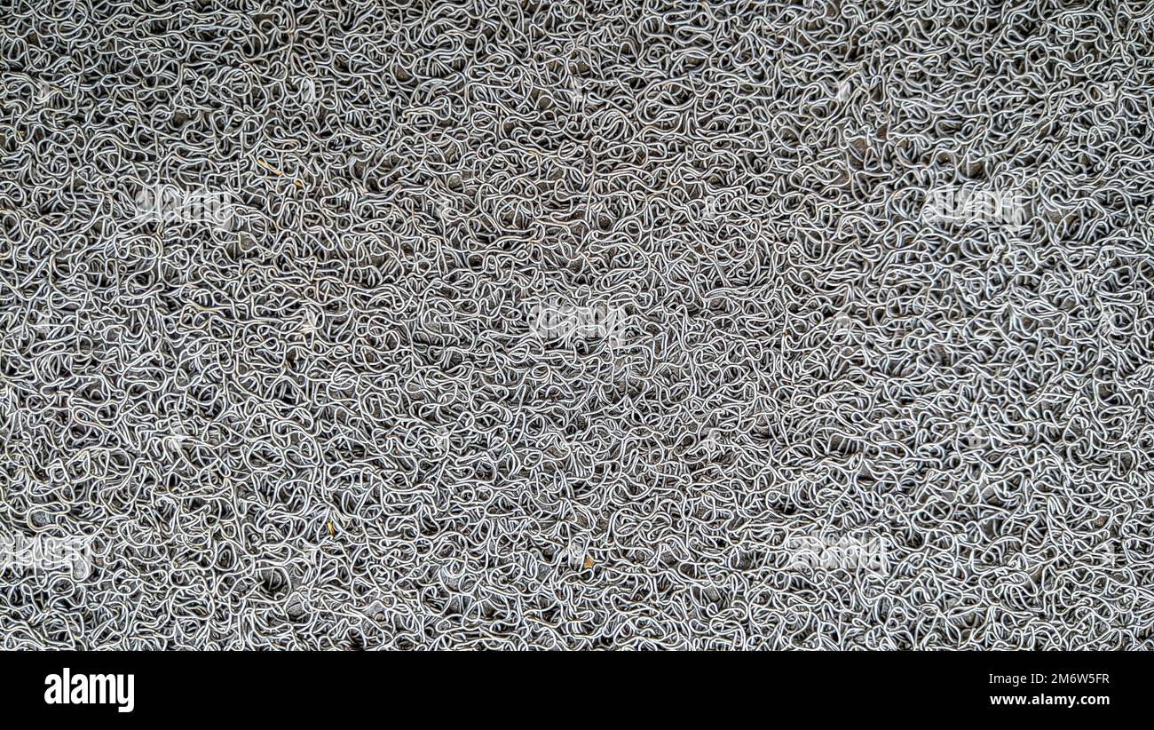 Fußmattenteppich mit Gummimaterial, gemusterter Teppichhintergrund. Stockfoto
