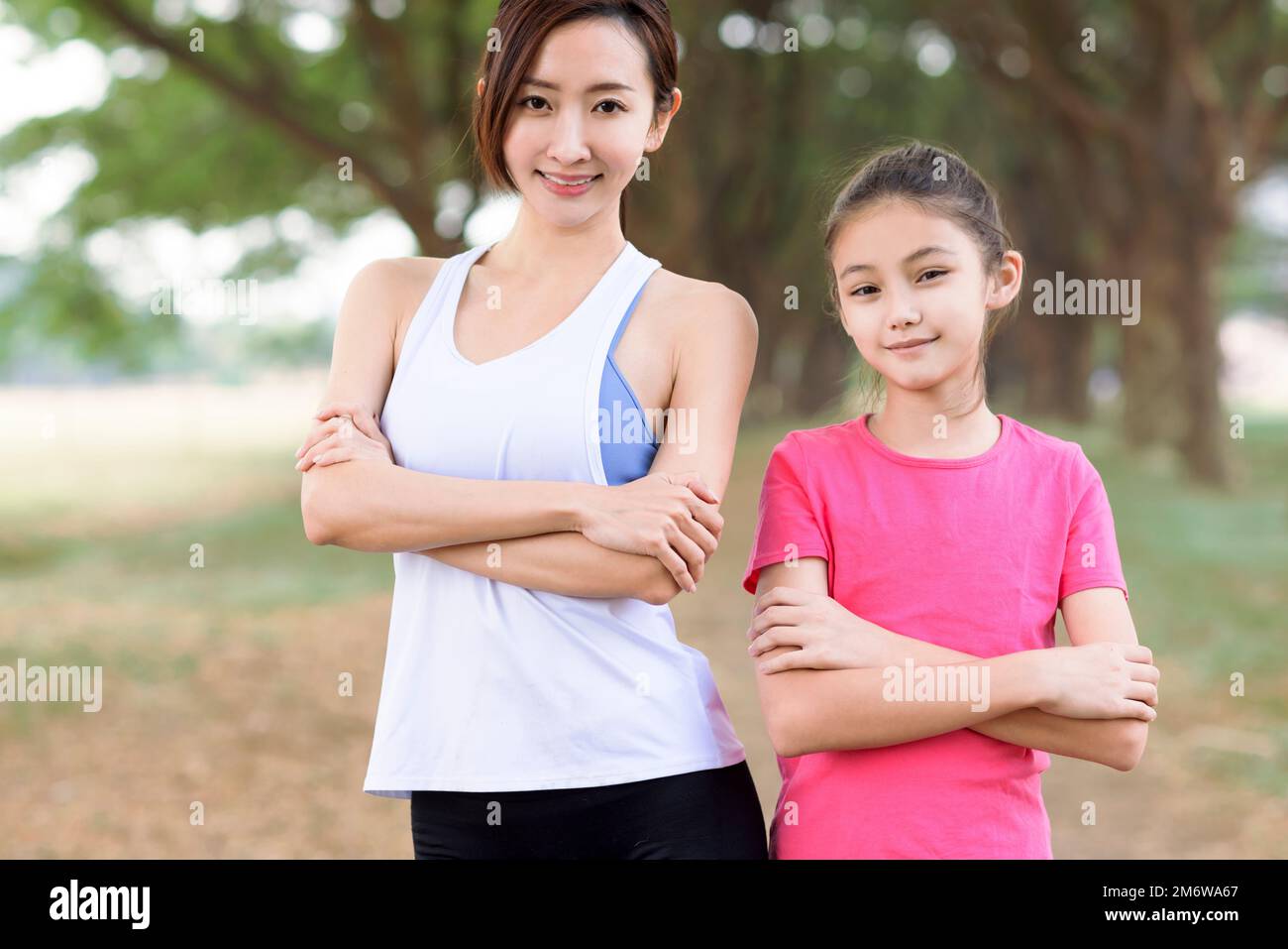 Fröhliche Mutter und Tochter beim Sport im Park Stockfoto