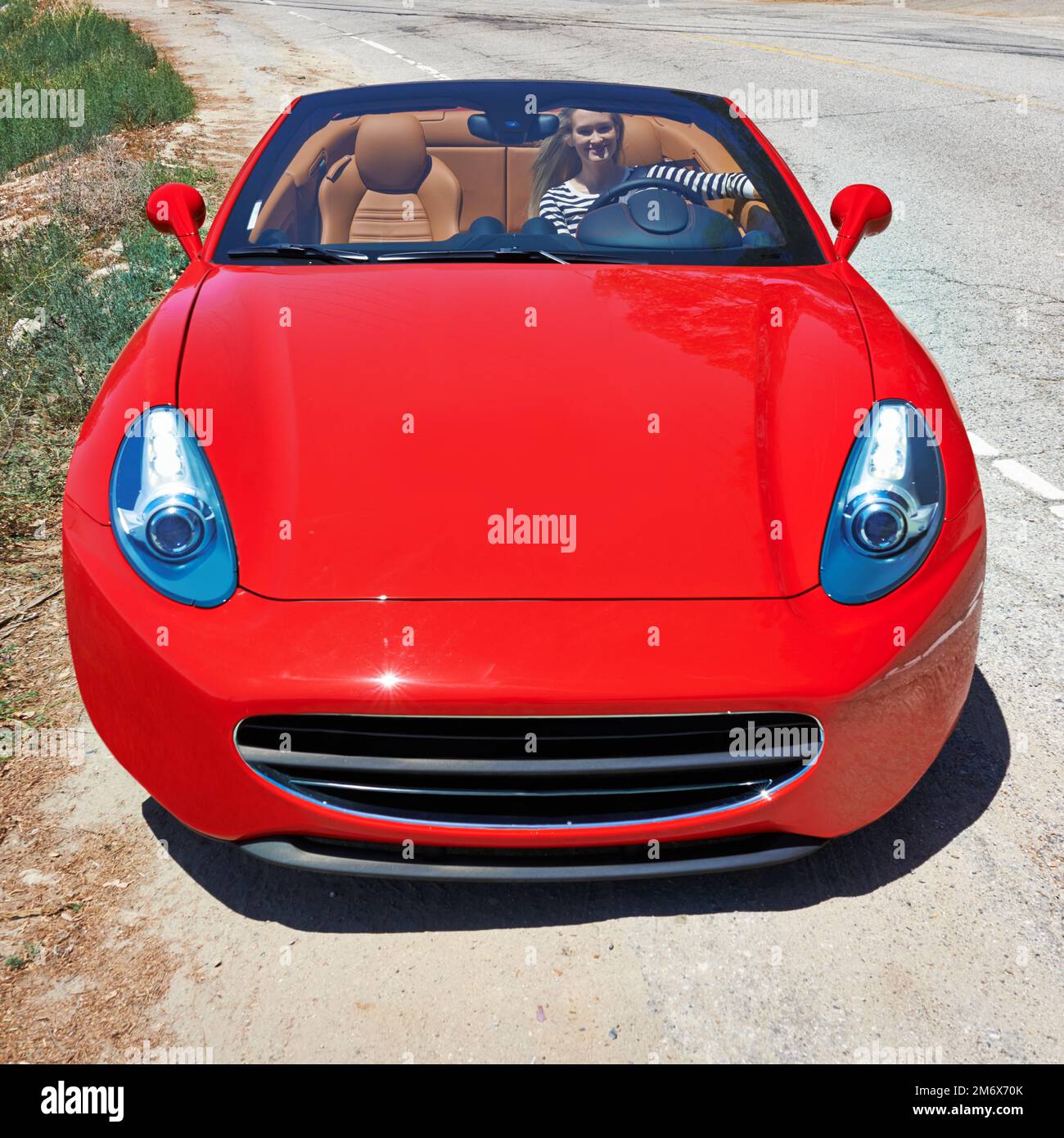 Symbol des Erfolgs... eine junge Frau, die in einem Sportwagen fährt. Stockfoto