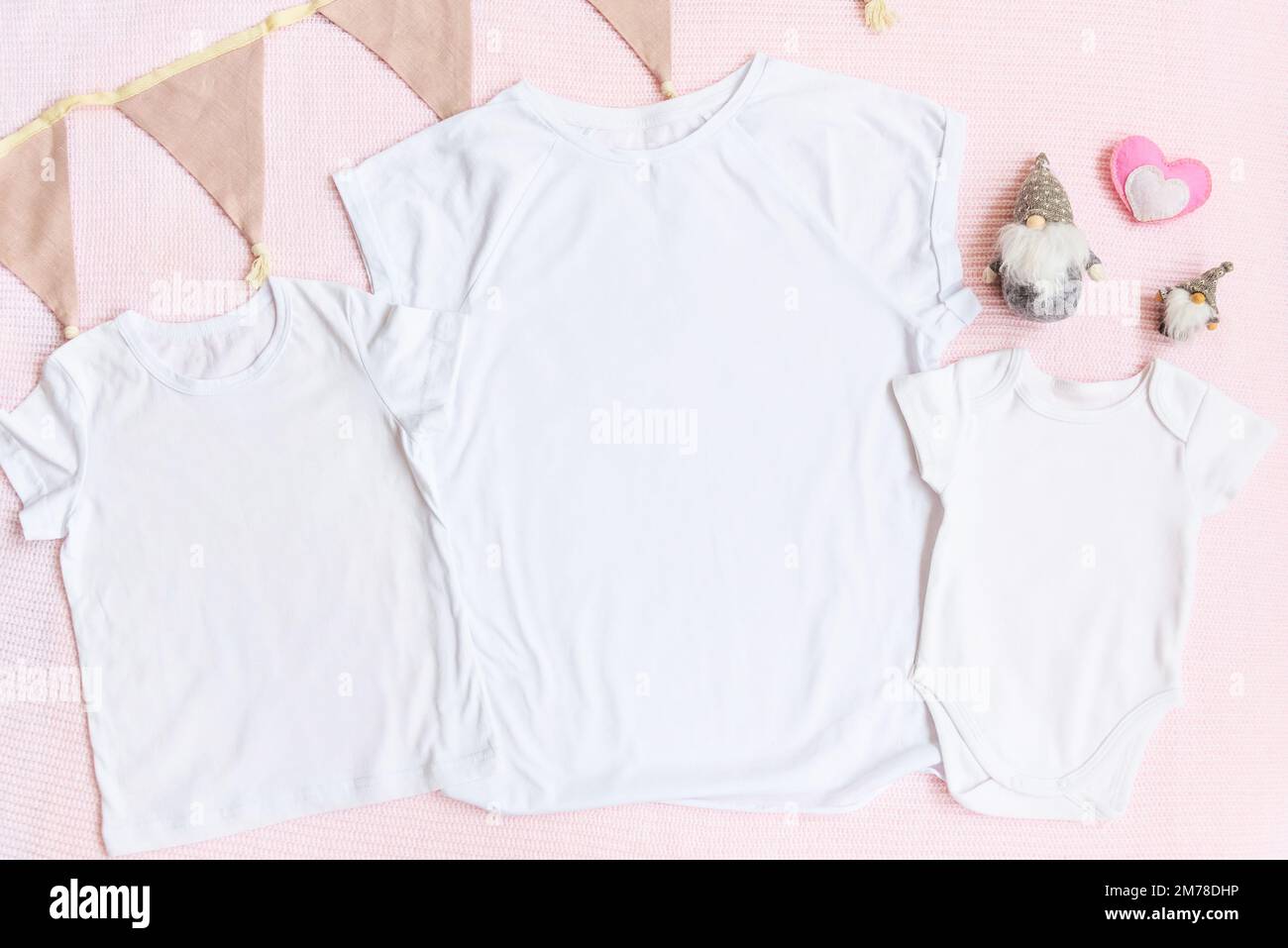 Ostern-T-Shirt und Einteiler mit Zwergen und Herz auf pinkfarbenem Hintergrund für eltern und Kinder Stockfoto