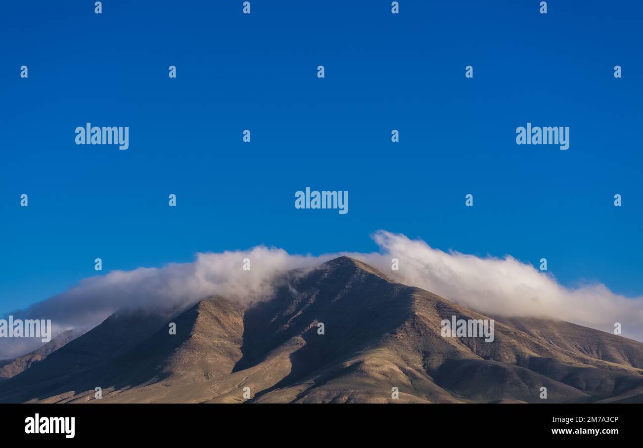 Die Berge/Vulkane in der Nähe von Playa Blanca, Lanzarote bedeckt mit Wolken am frühen Morgen. Stockfoto