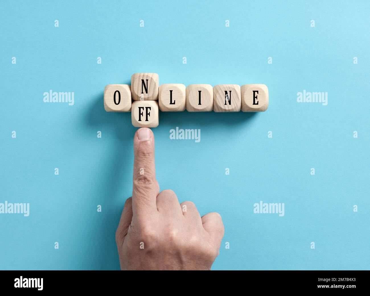 Offline gehen. Um zwischen Online und Offline zu wählen. Digitale Entgiftung. Männliche Hand verwandelt das Wort online in offline auf Holzwürfeln. Stockfoto