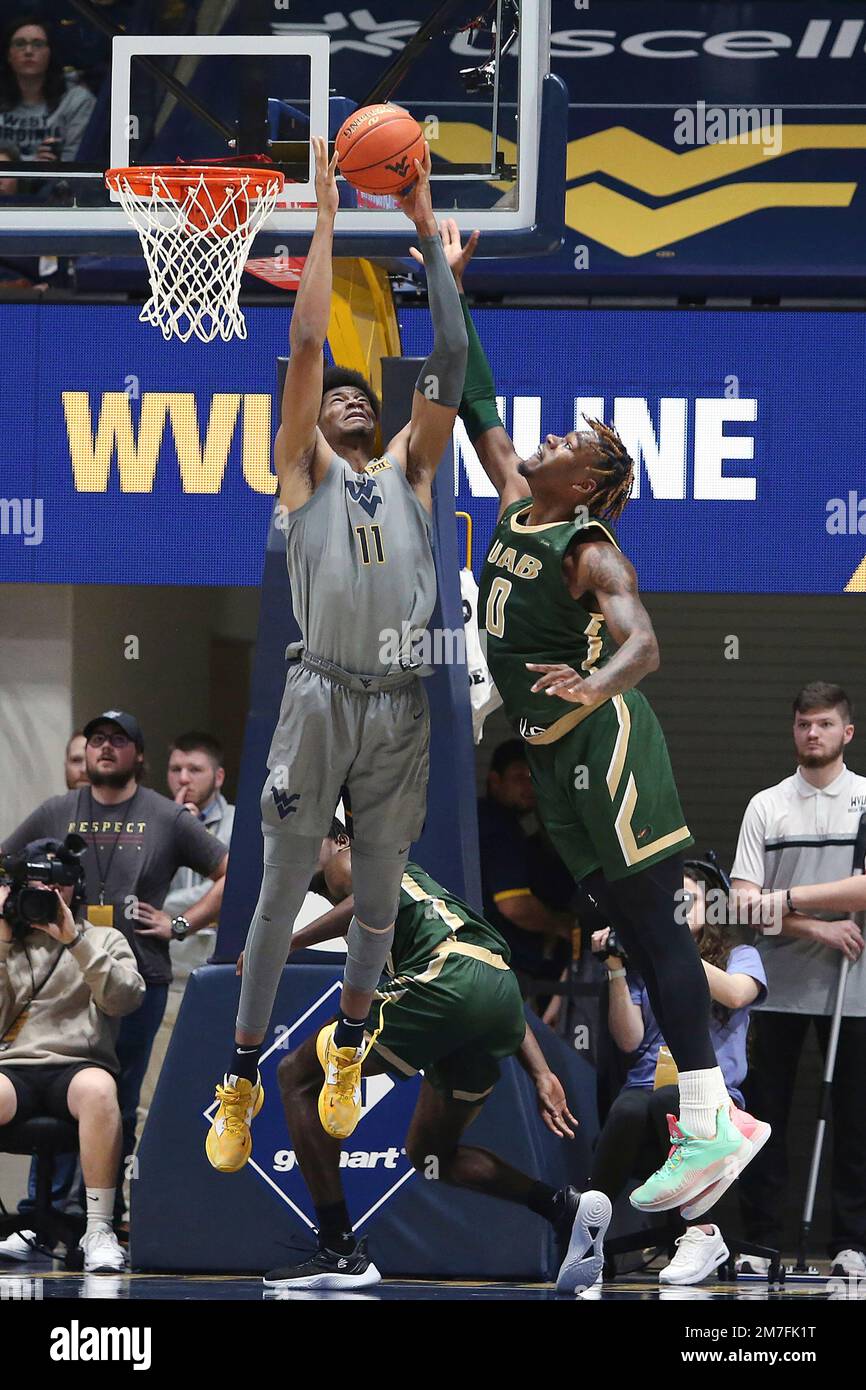 West Virginia forward Mohamed Wague (11) is defended by UAB forward