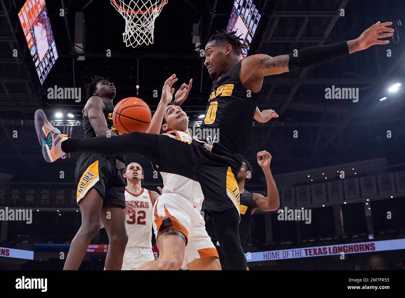 ArkansasPine Bluff guard Trejon Ware (0) battles Texas forward Brock
