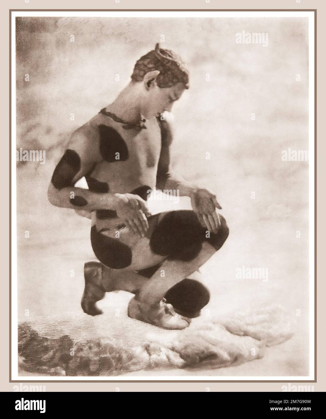 Vaslav Nijinsky hockte sich auf seinem linken Knie, Kopf gebeugt, vor einem Schal wie der Faun in L'Apres-Midi d'un Faune. Foto 1912 von Adolf de Meyer aus dem Buch „Nijinsky: L'Apres-midi d'un Faune“ aus dem Jahr 1914 Stockfoto Vaslav Nijinsky hockte sich auf seinem linken Knie, Kopf gebeugt, vor einem Schal wie der Faun in L'Apres-Midi d'un Faune. Foto 1912 von Adolf de Meyer aus dem Buch „Nijinsky: L'Apres-midi d'un Faune“ aus dem Jahr 1914 Stockfoto