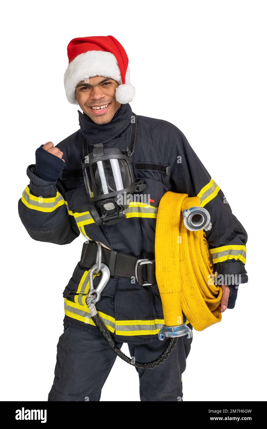 Ein lächelnder Feuerwehrmann, der zu Weihnachten die Faust kneift Stockfoto