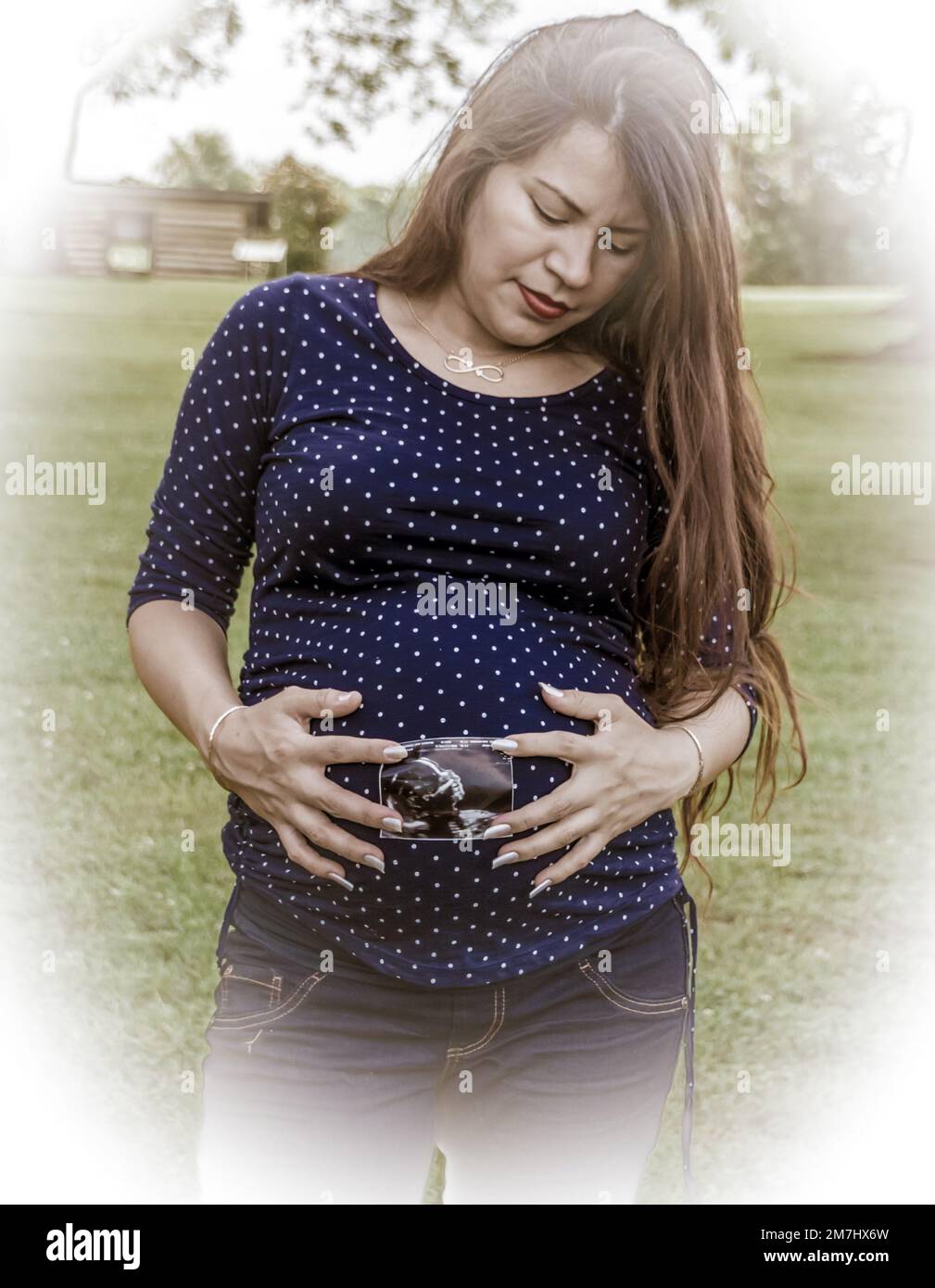 Latina-Frau, die ein Bild ihres ungeborenen Kindes in der Hand hält Stockfoto