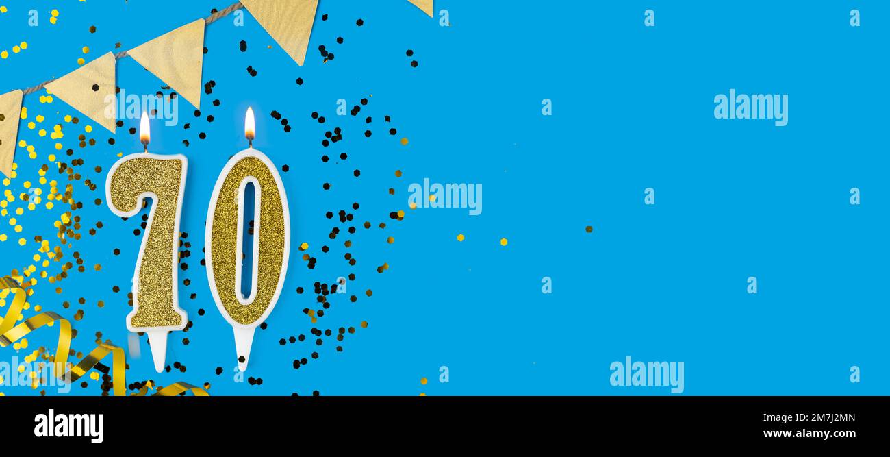 Goldene Kerze Nummer siebzig. Geburtstagskarte mit der Aufschrift 70 auf blauem Hintergrund. Jubiläumsfeier. Banner. Stockfoto