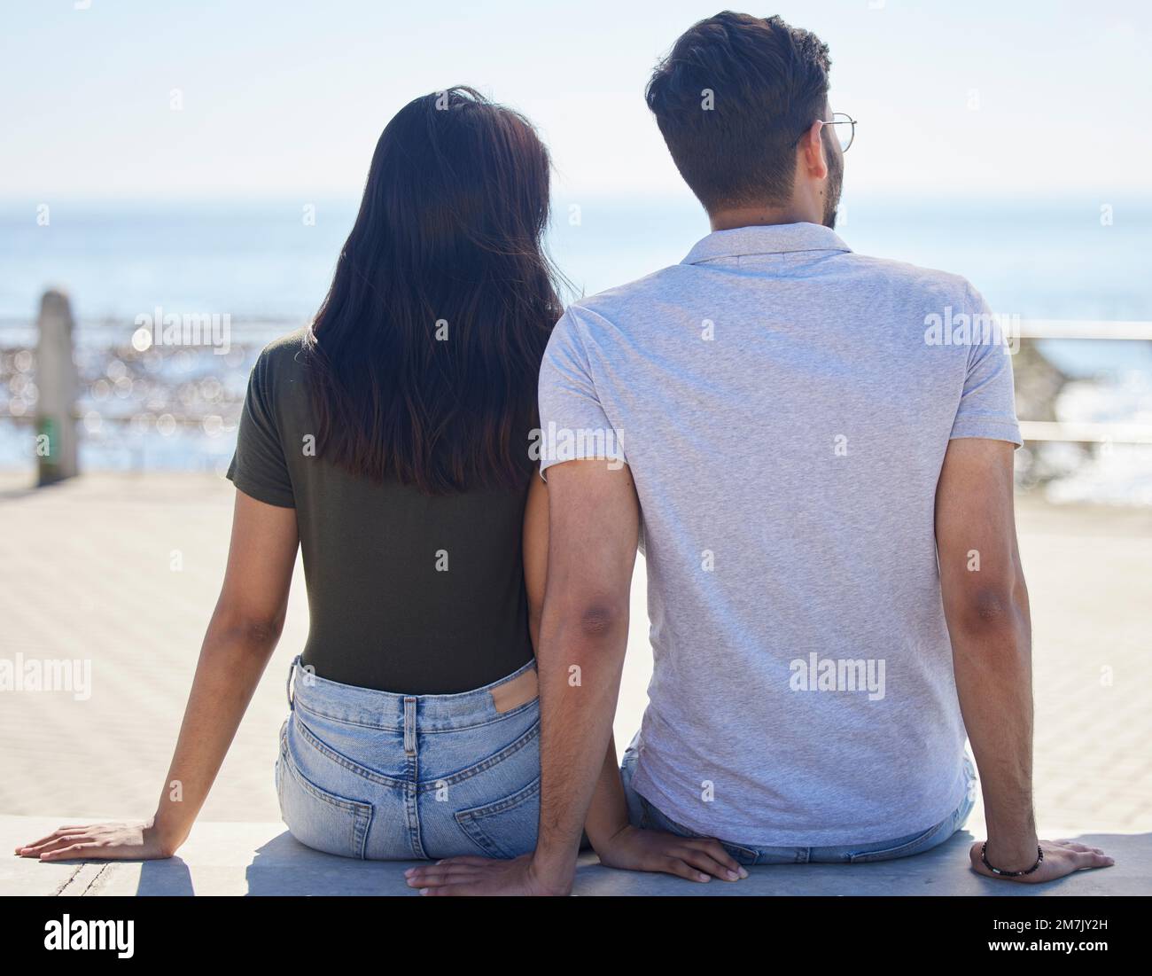 Strand, Aussicht und Liebe mit einem Paar auf der Promenade zusammen im Sommer am Meer oder Meer. Zurück, Verabredung und Urlaub mit Mann und Frau Stockfoto