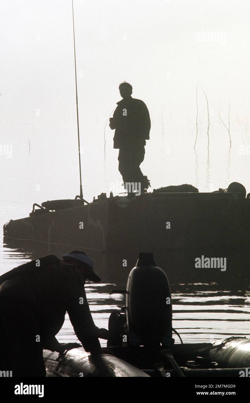 SPEZ. 4 Alfred Martinez, Mechaniker der 17. Ingenieure, 1. Kavallerie, steht auf seinem teilweise unter Wasser befindlichen Panzerwagen (APC) und wartet darauf, während der gemeinsamen Serviceoperation Gallant Crew '77 gerettet zu werden. Betreff Operation/Serie: GALANT CREW '77 Basis: Fort Hood Bundesstaat: Texas (TX) Land: Vereinigte Staaten von Amerika (USA) Stockfoto