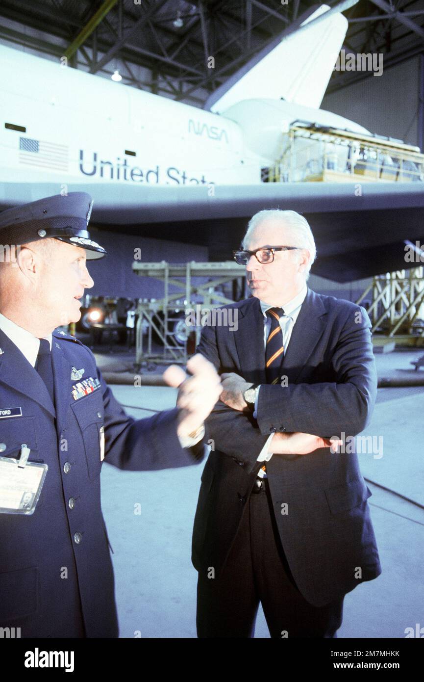 GENERAL Thomas Stafford, links, begleitet den Air Force-Minister John C. Stetson auf seiner Rundfahrt durch die Basis. Ein Space Transportation System (STS) Shuttle befindet sich im Hintergrund. Basis: Luftwaffenstützpunkt Edwards Bundesstaat: Kalifornien (CA) Land: Vereinigte Staaten von Amerika (USA) Stockfoto