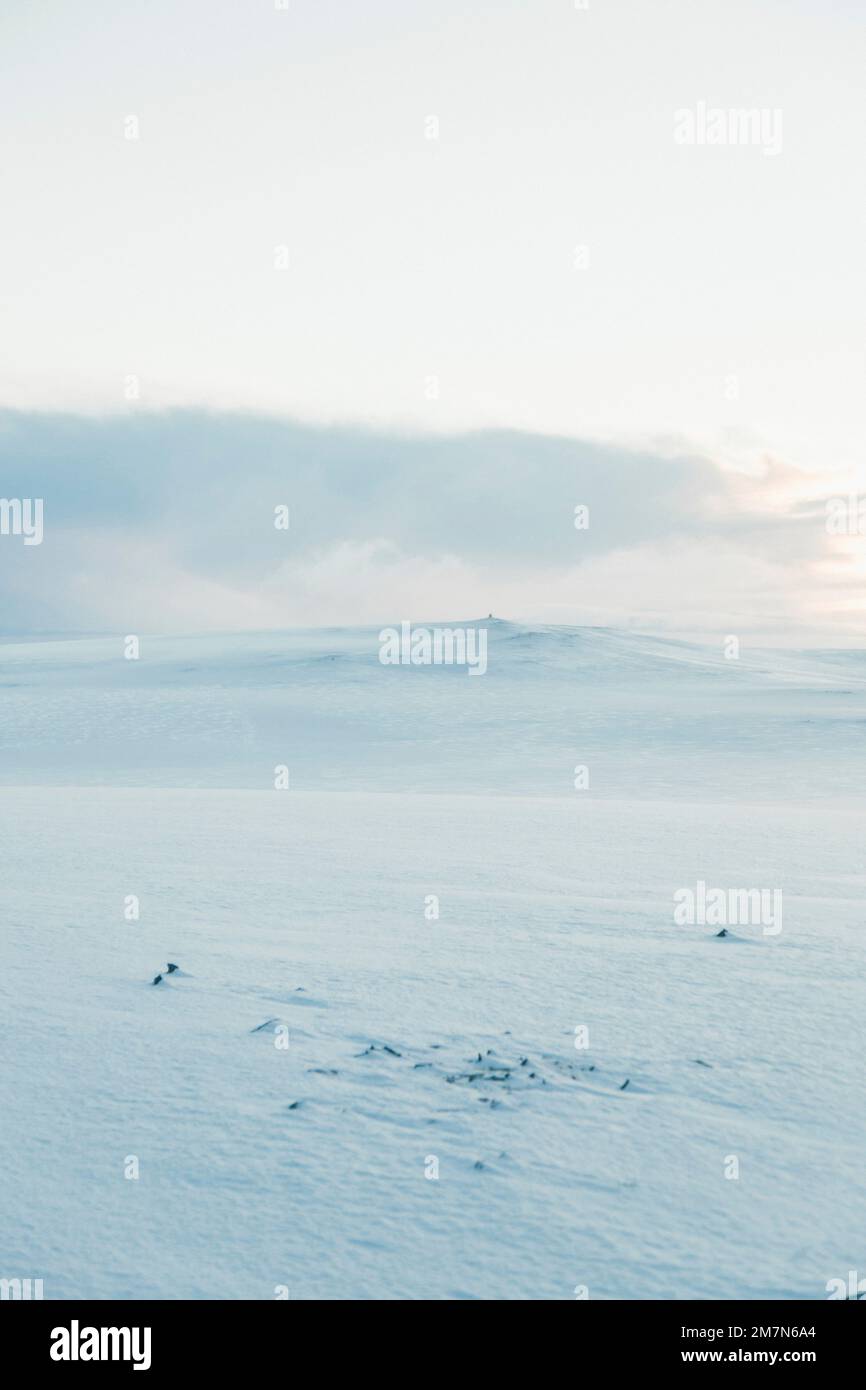 Verschneite Landschaft mit schneebedeckten Bergen in Norwegen, Schneesüste am Nordkap (Magerøya), Schnee- und Eislandschaft in Skandinavien Stockfoto