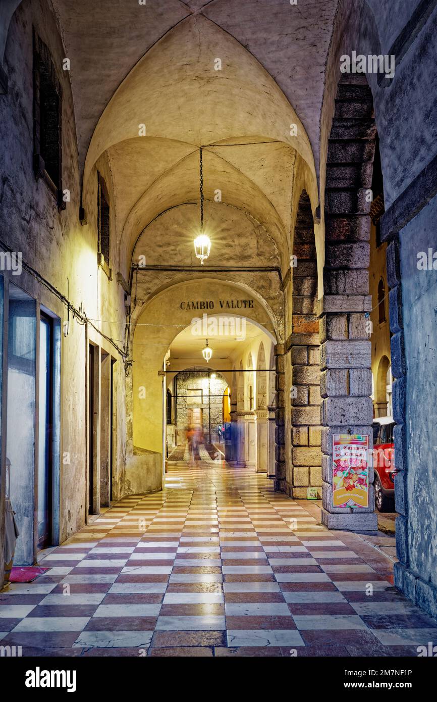 Die Beleuchtung unter dieser gewölbten Decke in der norditalienischen Stadt Vittorio Veneto schafft ein angenehmes Ambiente Stockfoto