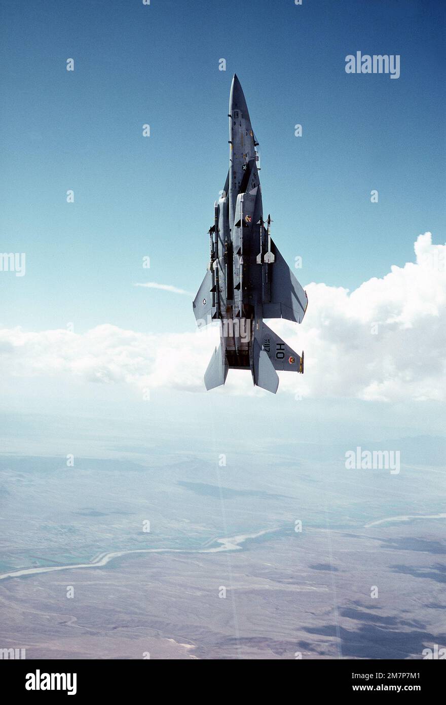 Eine Luft-Luft-Niederwinkelansicht von links eines F-15 Eagle-Flugzeugs bei einem vertikalen Aufstieg über die White Sands Raketenreichweite am Luftwaffenstützpunkt Holloman. An jedem Flügel sind zwei SIDEWINDER-AIM-9-Raketen und an jeder Seite des Rumpfs zwei SIDEWINDER-7-Raketen angebracht. Das Flugzeug ist dem 49. Taktischen Kampfflugflügel zugewiesen. Staat: New Mexico (NM) Land: Vereinigte Staaten von Amerika (USA) Stockfoto