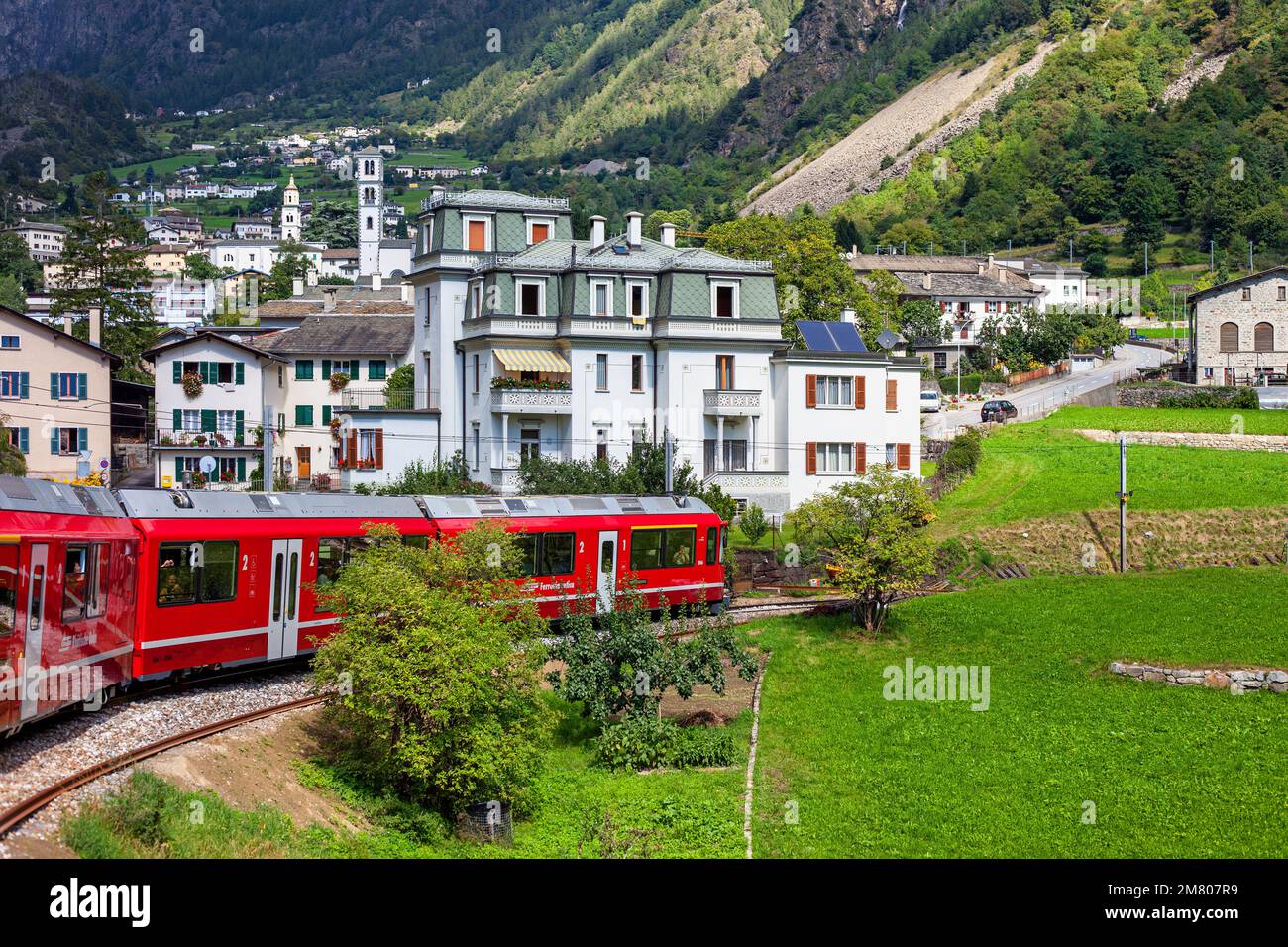 BERNINA Expresszug im Bergdorf Brusio bei Poschiavo, in der Region Bernina, Kanton Grisons, Schweiz. Stockfoto
