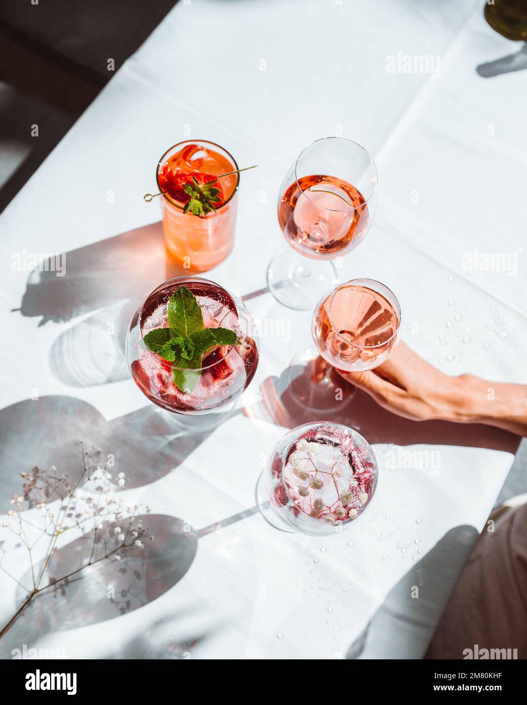 Verschiedene Sorten Wein und Wein Cocktails in Gläsern, zubereitet für die Verkostung auf einem weißen Tisch im Innenbereich Stockfoto