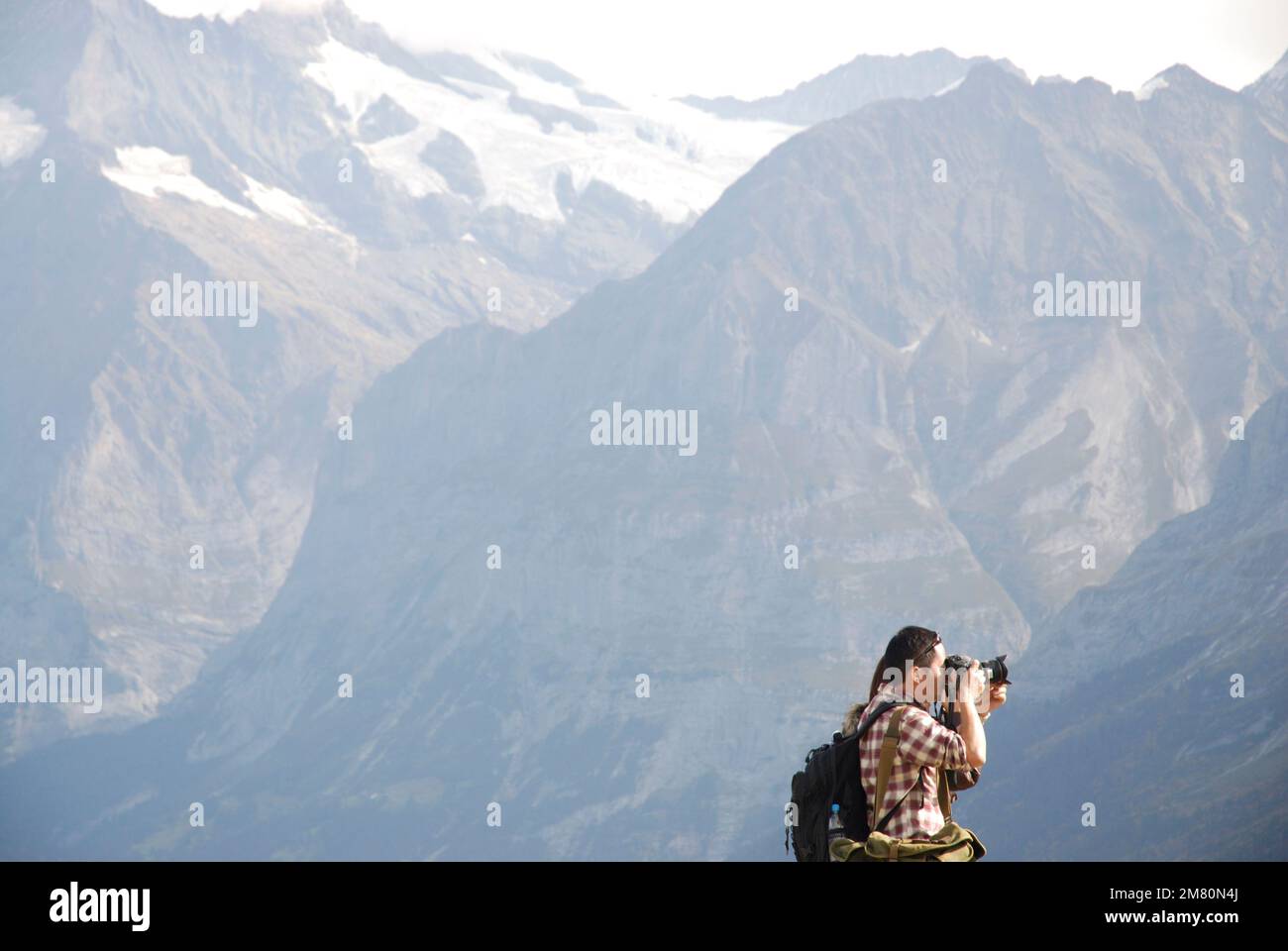Wanderer in den Bergen der Schweiz genießen den Panoramablick mit dem Fernglas Stockfoto