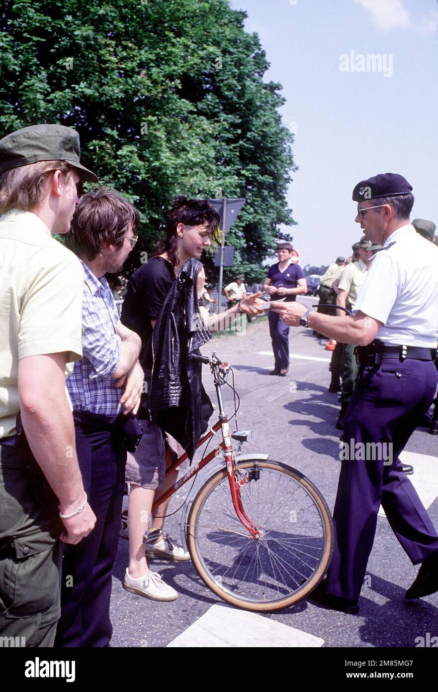 MASTER Sergeant Samie Halsey, 435. Sicherheitspolizei-Geschwader, gibt einen jungen deutschen Pass zurück, nachdem sie ihr den Zutritt zur Basis und die Feierlichkeiten verweigert hat. Der Luftwaffenstützpunkt wird aufgrund politischer Demonstrationen außerhalb des Haupttor und terroristischer Bedrohungen unter äußerst strengen Sicherheitsbedingungen betrieben. Basis: Rhein-Main-Luftwaffenstützpunkt Land: Westdeutschland (BRD) Stockfoto
