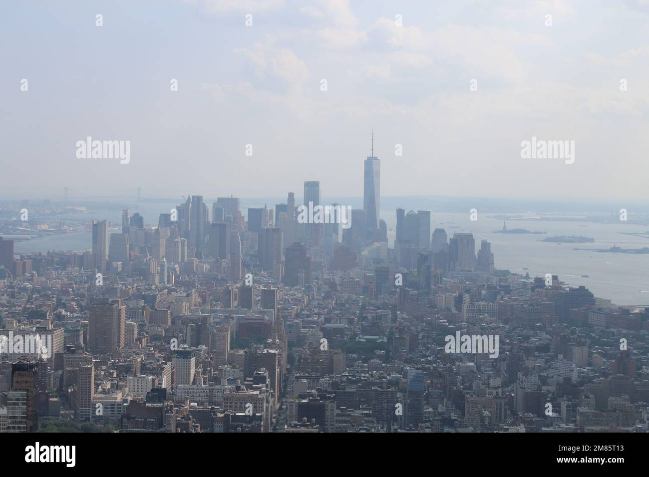 Wunderschöner Blick auf die Stadtlandschaft von New York und die Freiheitsstatue bei Sonnenuntergang Stockfoto
