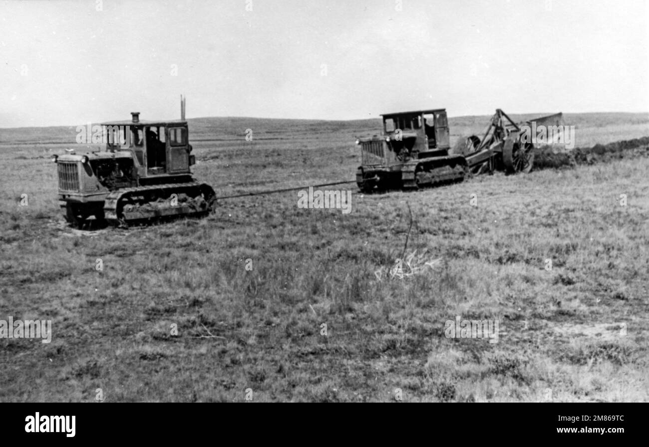 Kasachische SSR, UdSSR - ca. 1955: Zwei Traktoren Stalinets-80 pflügen Junglandschaften Stockfoto